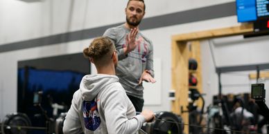 An instructor explains key aspects of effective and efficient rowing at Orleans CrossFit | OCFIT.
