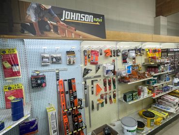 Hardware store aisle with tools and construction supplies.