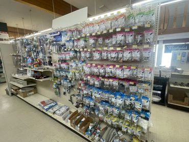 Hardware store aisle with plumbing supplies and fixtures.