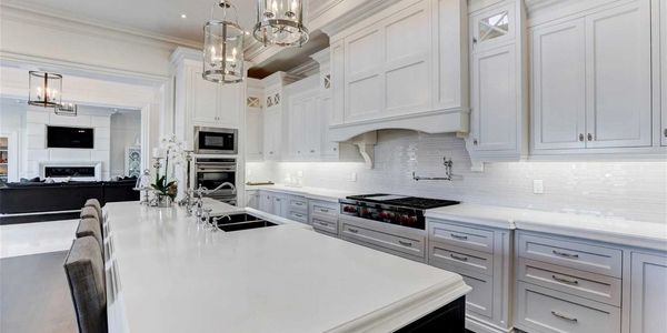 Luxury kitchen featuring quartz island and stainless steel appliances