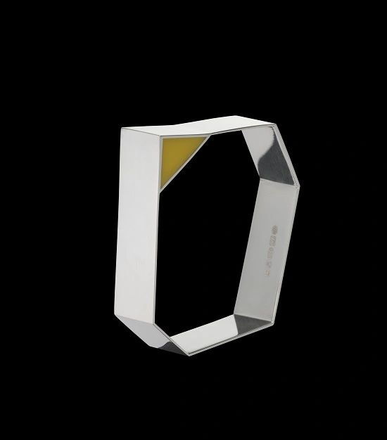 Geometrical silver bangle with yellow perspex decoration.