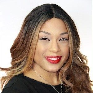 Smiling woman with long ombre hair and red lipstick.