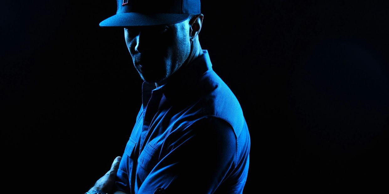 Image of Owner and photographer, moody lighting, shadows across face, staring into camera.