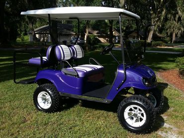Blue golf cart with tan seats