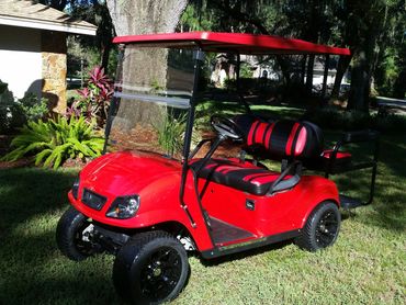 Red golf cart with striped seats