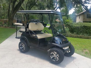 Dark green golf cart on driveway