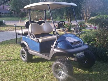 Blue golf cart with tan seats