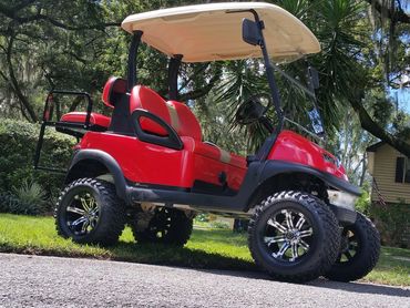 Red golf cart with tan roof