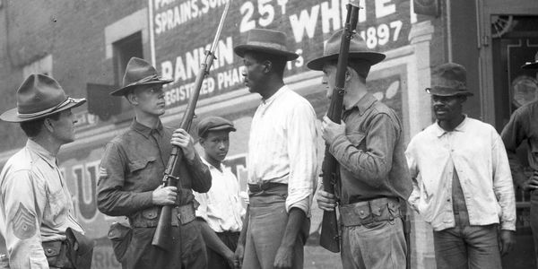 An old photo of men holding guns