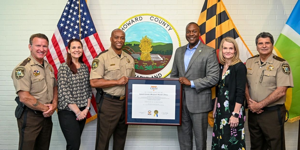 Group photo with certificate at Howard County office.
