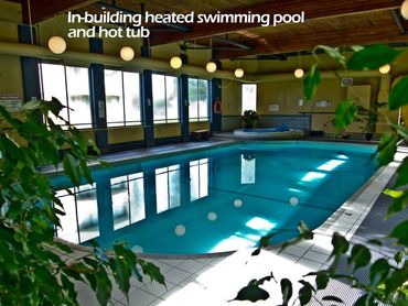 Indoor pool in an atrium setting in the annex of Roberts House Condo Building. Hot tub and gym too