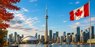 Toronto skyline with Canadian flag and waterfront view.