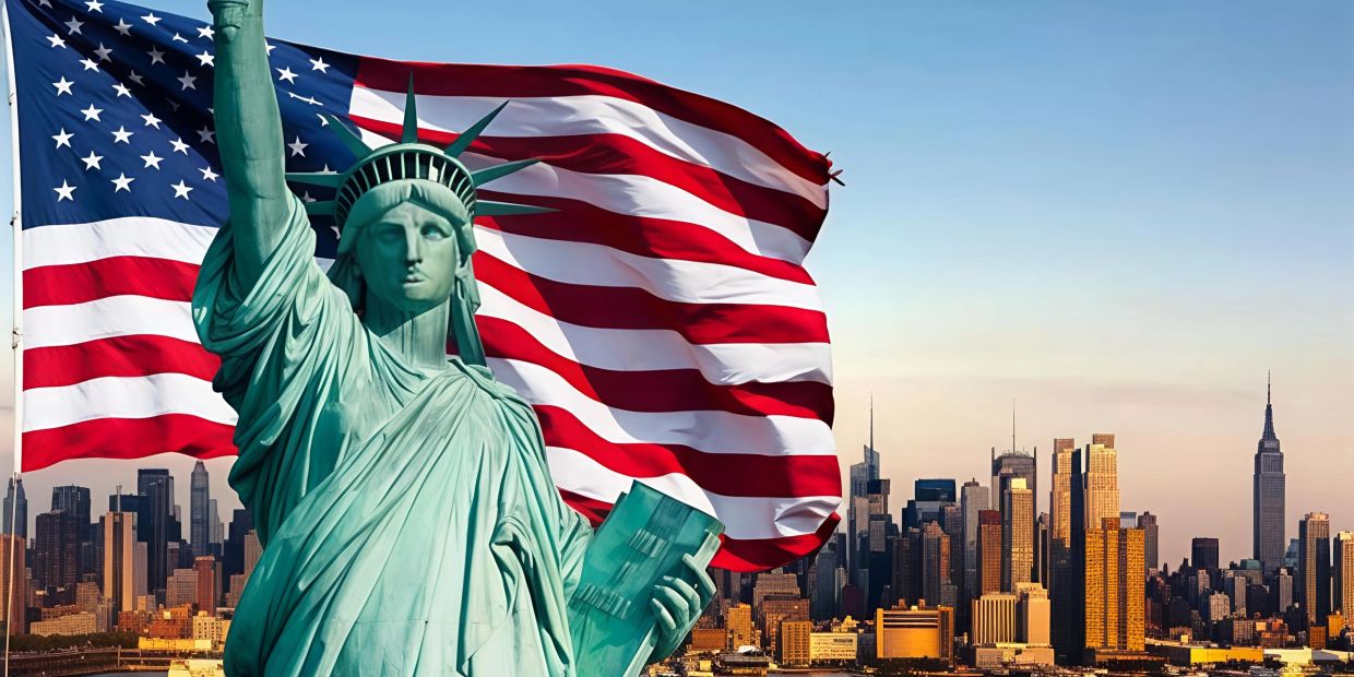 Statue of Liberty with American flag and New York skyline.