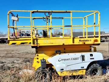 Yellow Haulotte Compact 336RT scissor lift outdoors.
