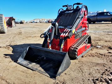 Red mini skid steer loader with bucket attachment.
