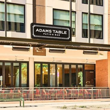 Exterior view of Adams Table Patio & Bar with outdoor seating area.