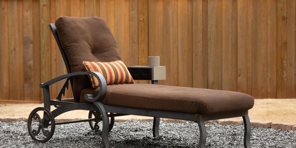 Adjustable side of the Adjustable Armchair Caddy on chaise lounge chair.