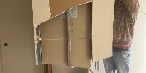 interior demolition: inside apartment building (demolishing drywall) 