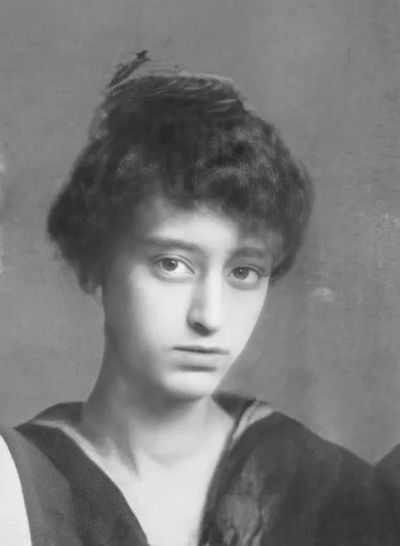 Black and white portrait of a young woman with curly hair.