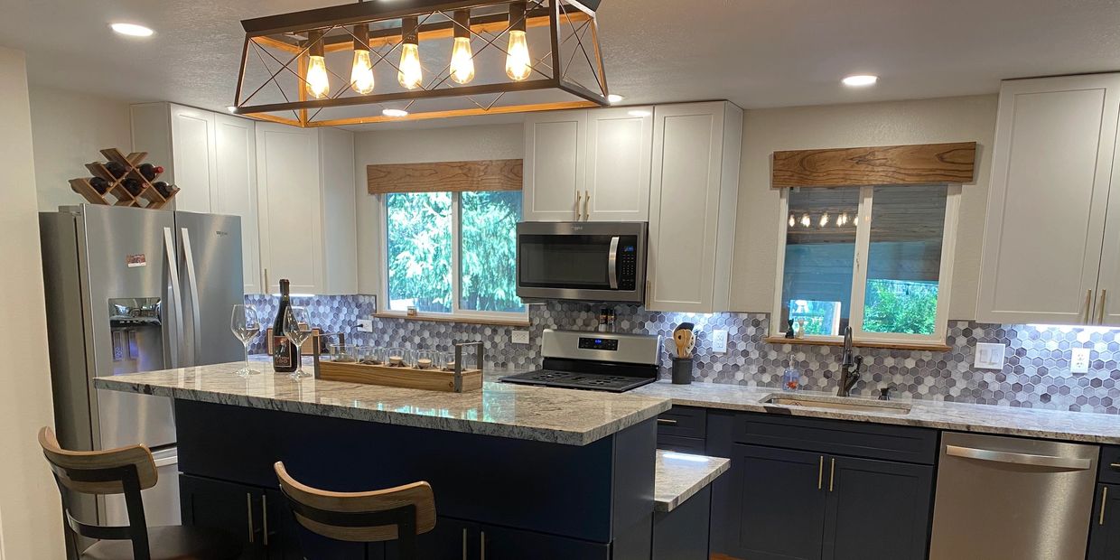 Open concept kitchen with granite countertops, hexagonal tile backsplashes and plank tile floors.