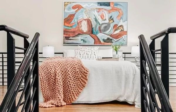 Loft bedroom decorated in corals and blues