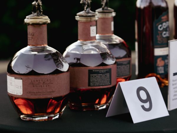 Three bottles of Kentucky bourbon whiskey on display with a number 9 card.