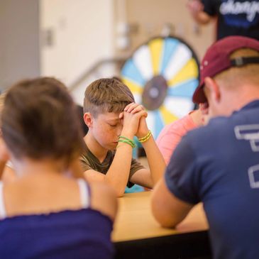 Photo of people bowing their heads in prayer