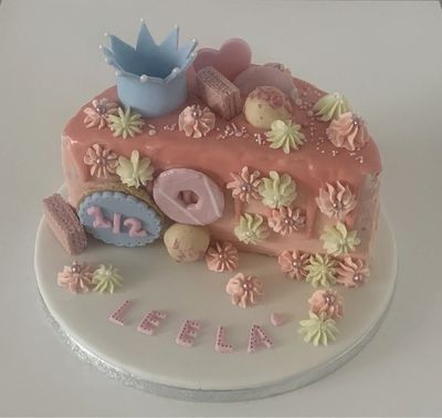Birthday cake, halved, decorated for a child. Celebration cakes a speciality.