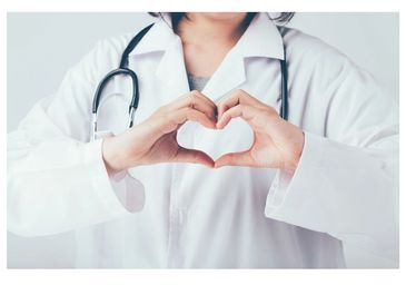 Doctor forming a heart shape with hands symbolizing care.