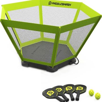 A green hexagonal pickleball rebounder with four paddles and three balls.