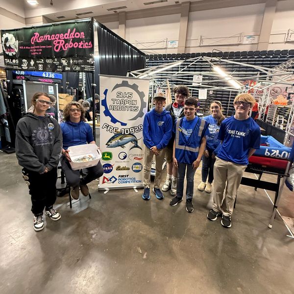 A group of students from SHS Tarpon Robotics at a robotics competition.
