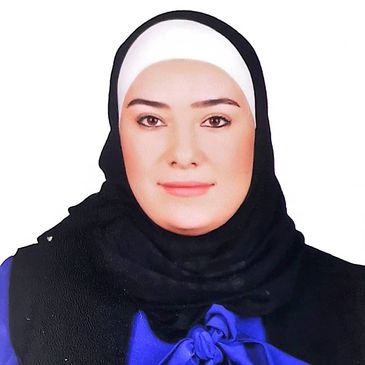 Portrait of a woman wearing a black hijab and blue outfit.