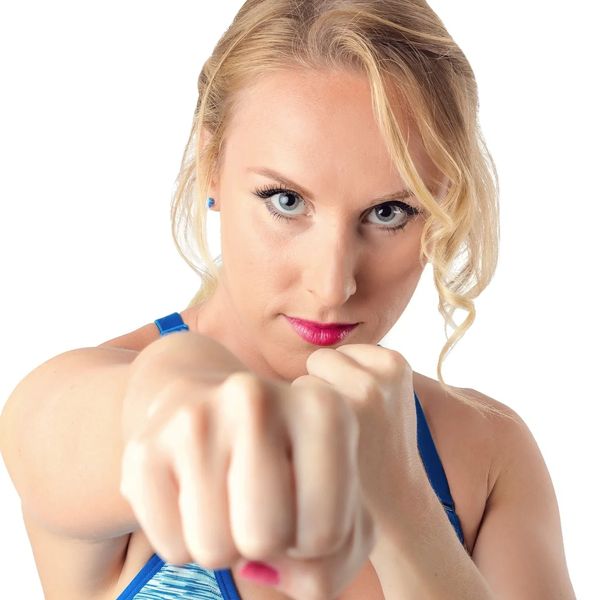 Confident woman throwing a punch.
