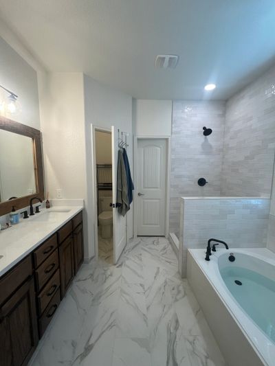 Bathroom remodel project completed in Rockwall, TX. Bathroom renovation included new tub, tiling, va