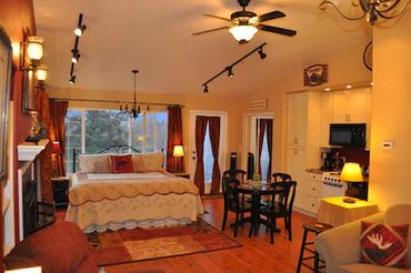 a spacious hall with a large bed, table, and more.