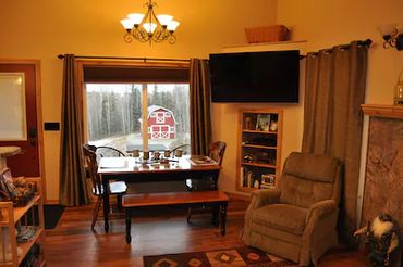 A room with a table, window, and a chair