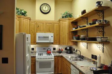 a small kitchen with cabinets and shelves