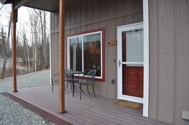 a patio with two chairs and a table