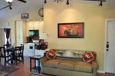 A sofa and a Moose painting above it