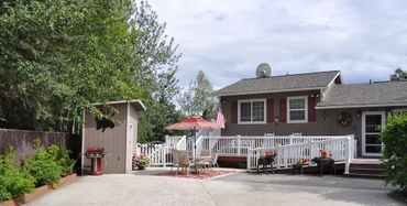 Front view of a house with outdoor seating arrangement