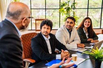 Business meeting with professionals listening attentively in a bright office.