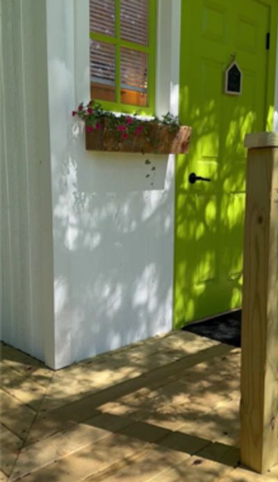 a picture of a bright green door leading to the private indoor bathroom