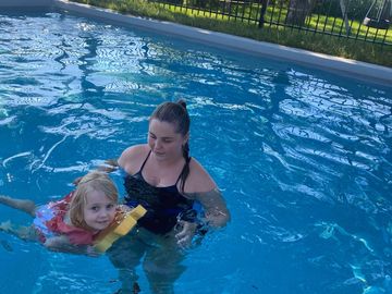 A woman and a child enjoying time together in a swimming pool.
