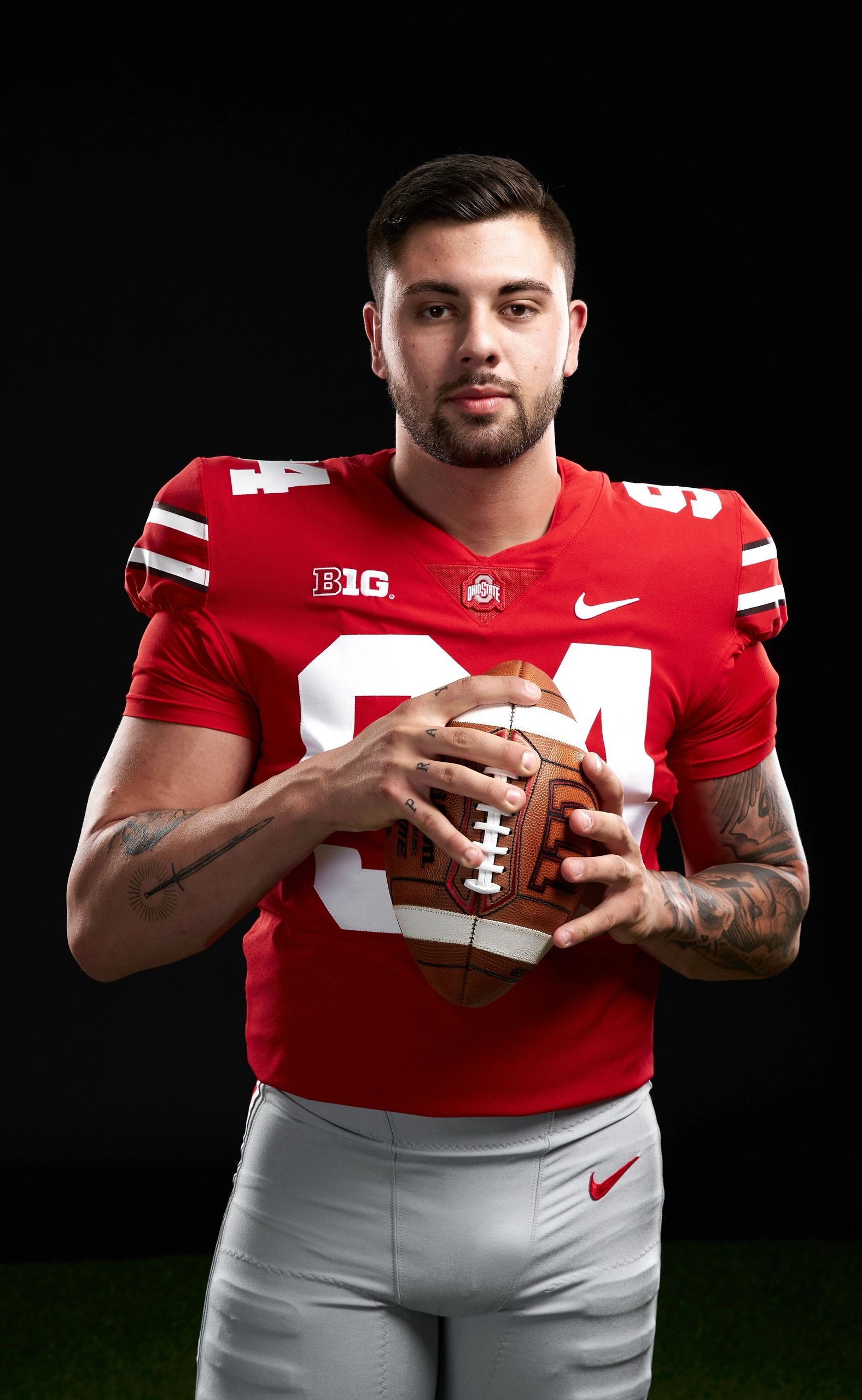 Roen McCullough in an Ohio State football uniform holding a football