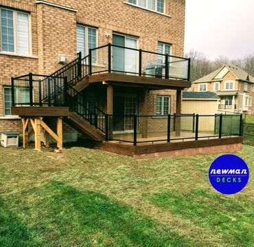 Two level composite deck with glass aluminum railings.