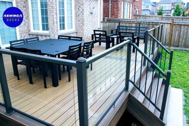 Floor level TREX composite deck with glass aluminum railings.