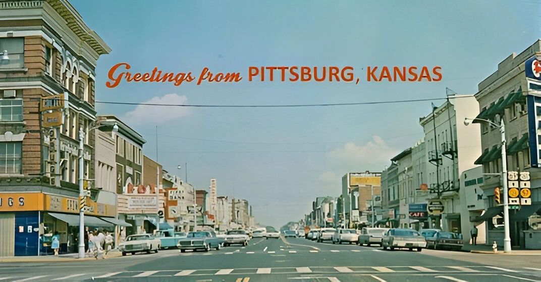 Street view of Pittsburg, Kansas with vintage cars.
