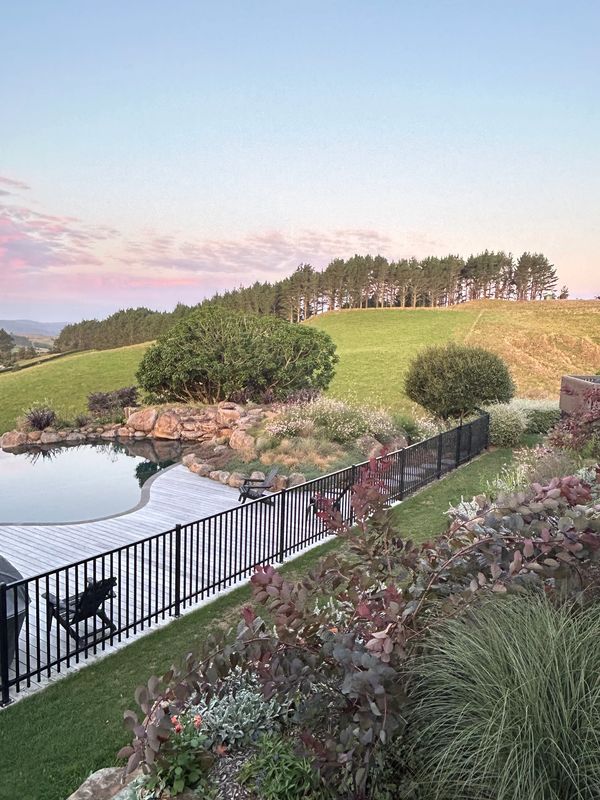 North American inspired pool.  Guara and carex grasses planted around boulders.  Rolling hills.  Cou