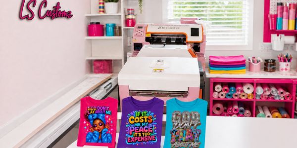 Custom T-shirts displayed in front of a printing machine.