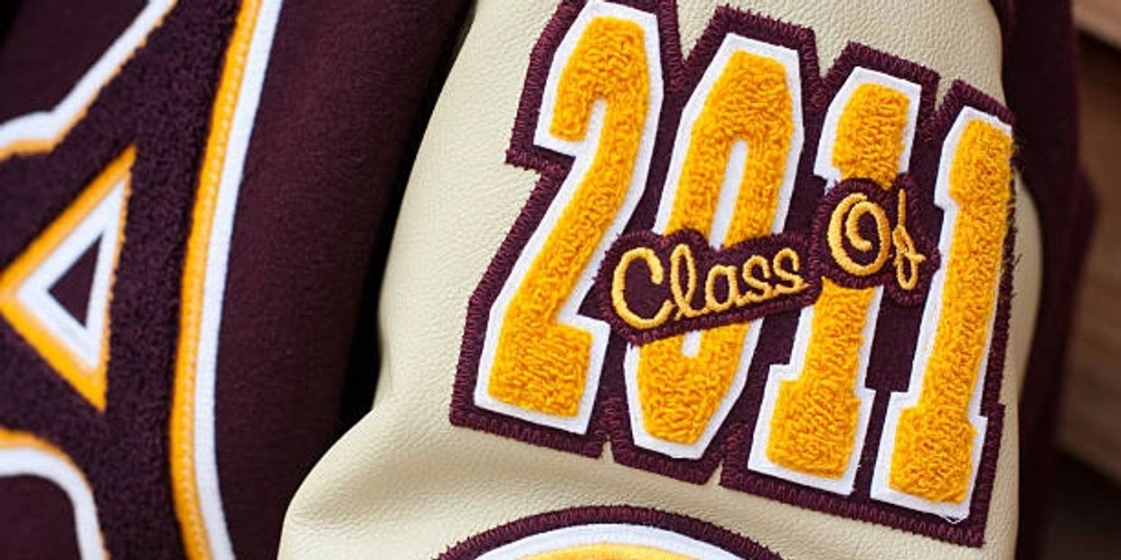 Close-up of a varsity jacket sleeve with "Class of 2011" patch.